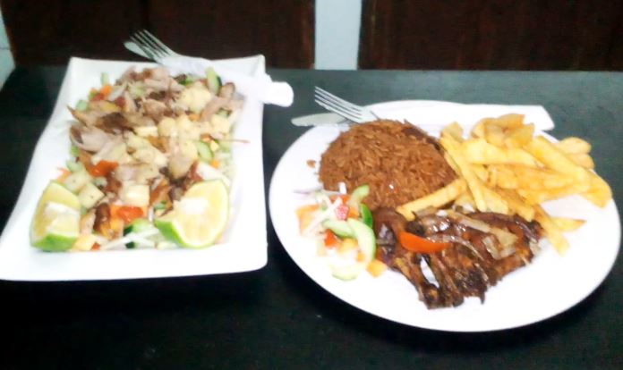 Chicken leg served with chips pilau